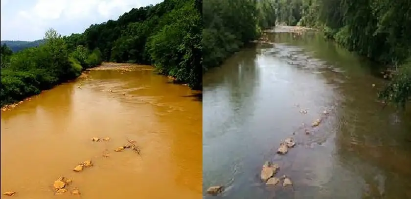 Two jars of creek water, one clear and one stained orange, beside an orange-tinted stream