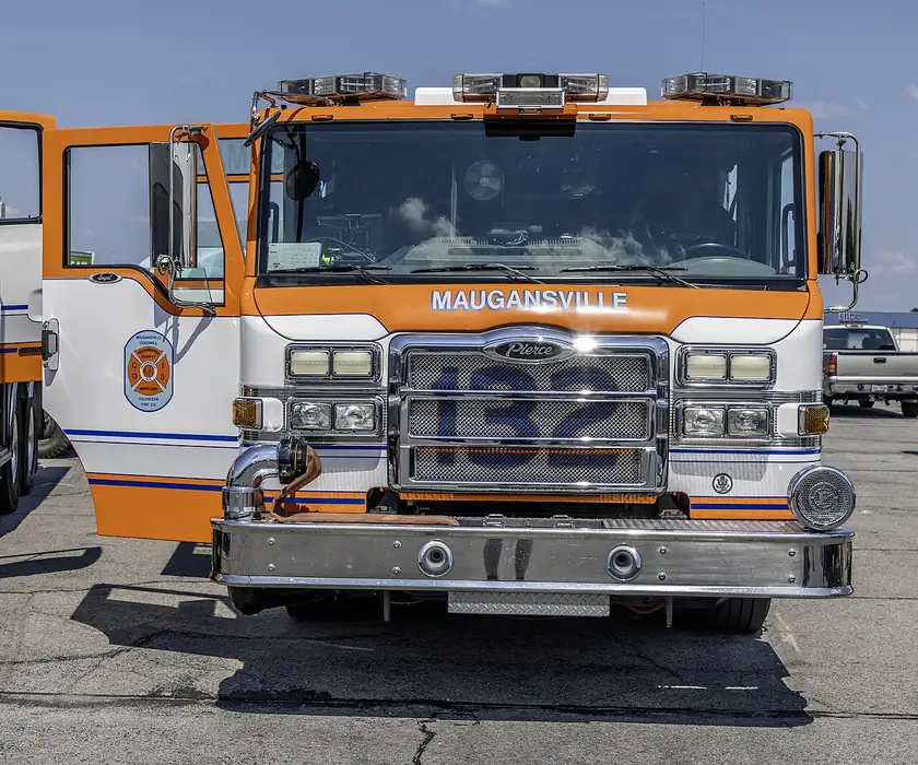 A white and red volunteer fire engine parked on pavement