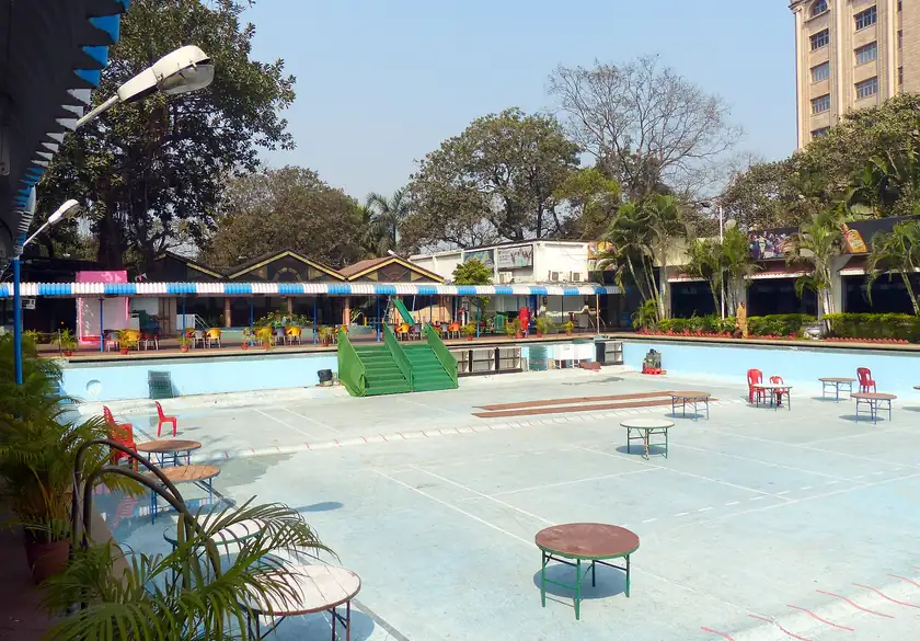 An empty outdoor swimming pool closed for winter, with no people