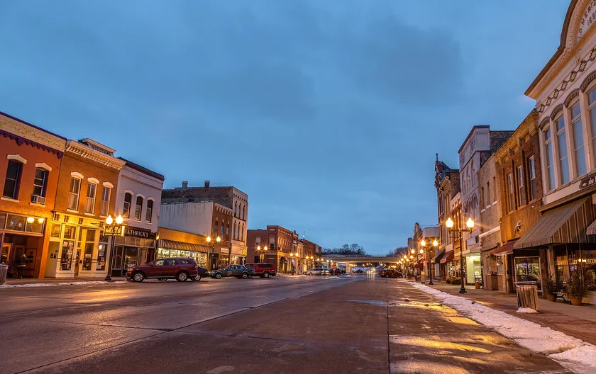 Historic brick storefronts along Second Street in downtown Hastings at dusk