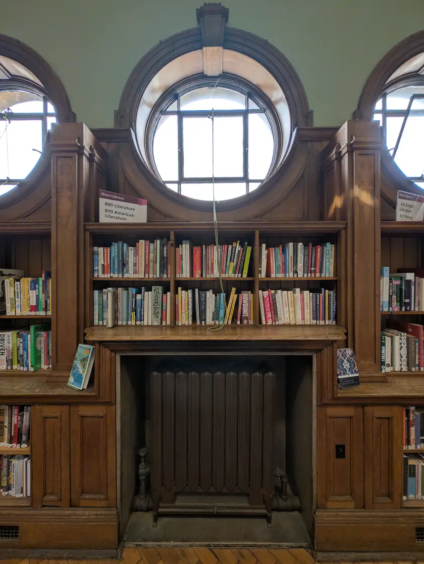 Tall wooden bookshelves filled with books in a library