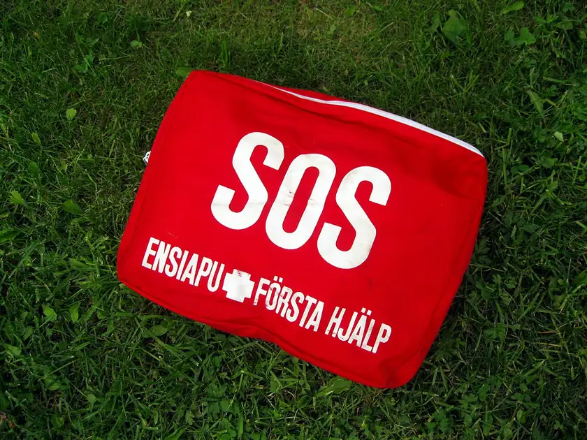 An open red first-aid kit with bandages and supplies inside