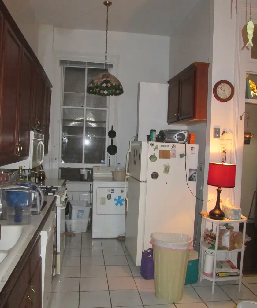 An open white kitchen refrigerator with empty shelves