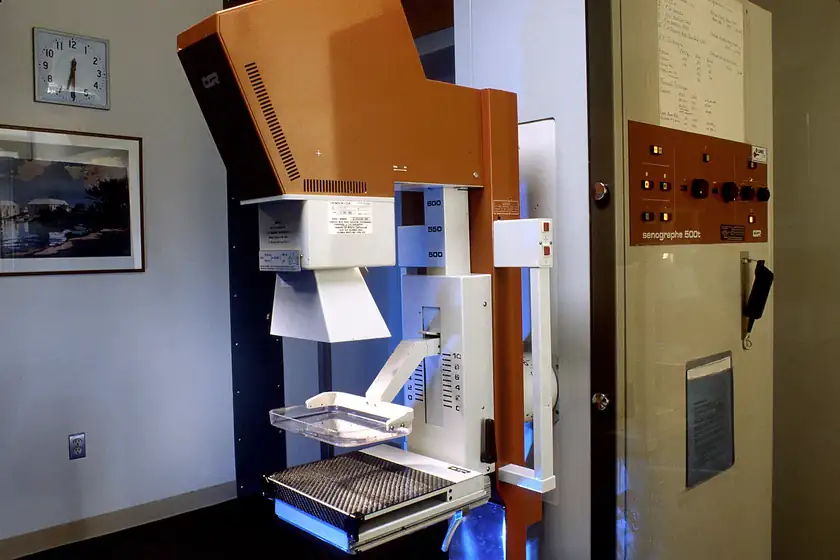 A mammography machine in a clinic room, with no patient