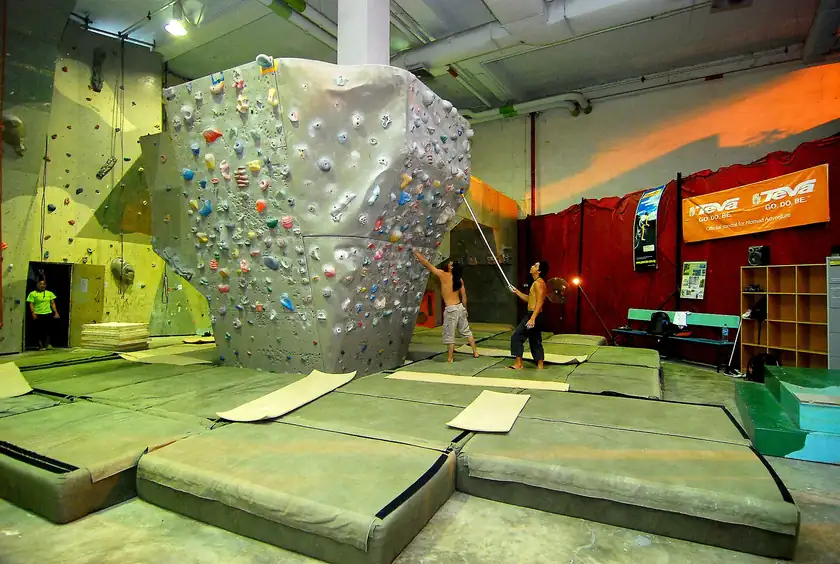 An indoor bouldering wall with mats and no climbers