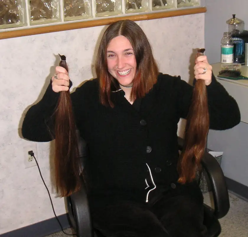 A thick lock of cut brown hair tied as a donation, with no people