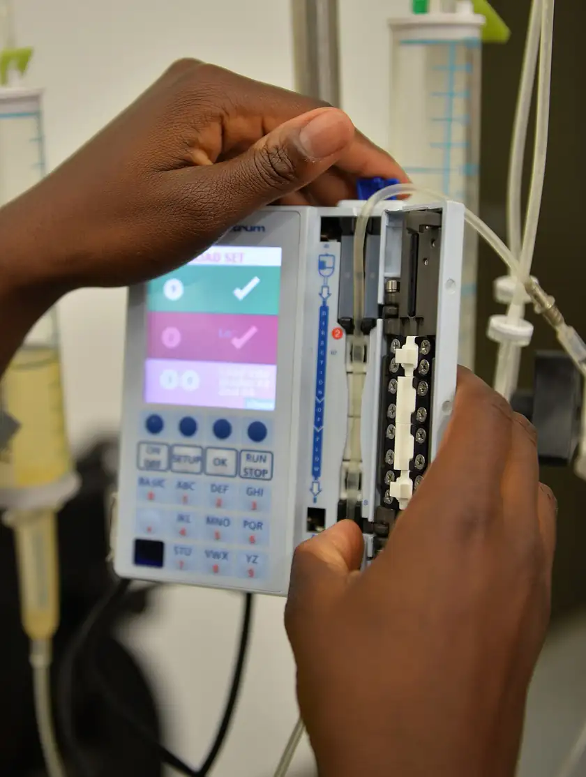 A hospital infusion pump on a stand