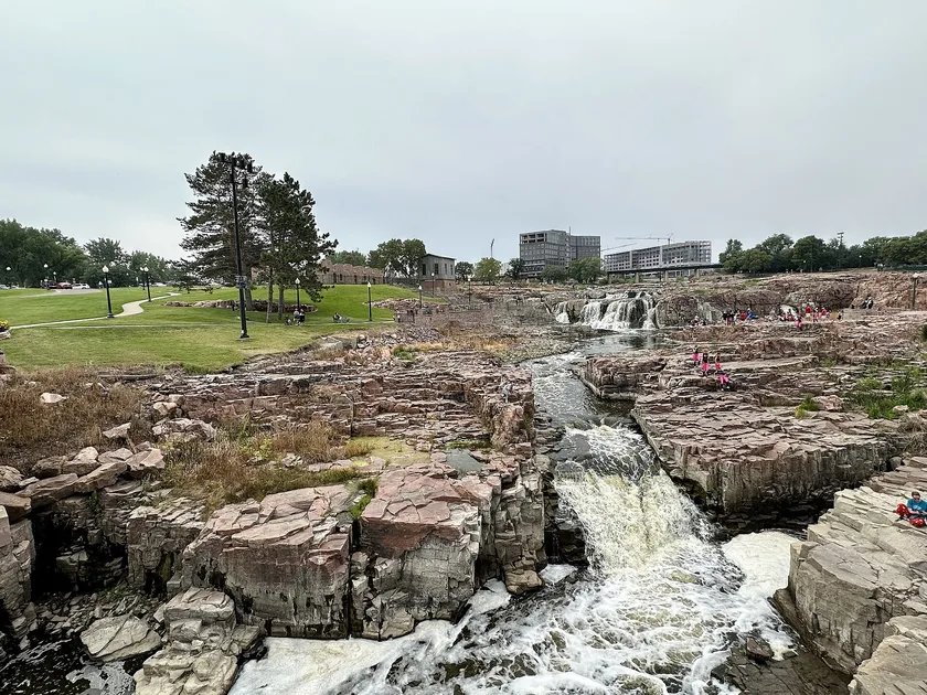 Water flowing over pink quartzite rocks at Falls Park in Sioux Falls