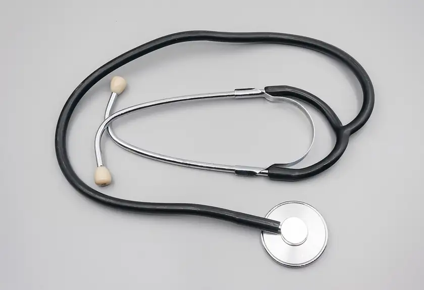 A stethoscope lying on a white surface